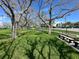 Grassy area with mature trees and benches, perfect for relaxing and enjoying the outdoors at 12132 Capri S Cir, Treasure Island, FL 33706