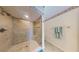 View of seamless glass shower featuring decorative tile, a bench, and shower niche at 12132 Capri S Cir, Treasure Island, FL 33706