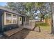 Relaxing backyard with a wooden deck, lush green grass, and mature trees providing shade at 1225 22Nd S Ave, St Petersburg, FL 33705