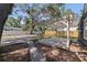 Backyard view with a wooden pergola, a concrete path, and a well-kept lawn. Perfect for entertaining or relaxing outdoors at 1225 22Nd S Ave, St Petersburg, FL 33705