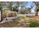 Backyard with a deck and patio area. The yard is fenced and has mature trees at 1225 22Nd S Ave, St Petersburg, FL 33705