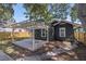 Rear exterior of the home showing a deck, small backyard and mature trees at 1225 22Nd S Ave, St Petersburg, FL 33705
