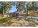 Back exterior of the home featuring a deck and a spacious, tree-filled backyard at 1225 22Nd S Ave, St Petersburg, FL 33705