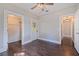 Bedroom with hardwood floors, a ceiling fan, closet and door leading to another room at 1225 22Nd S Ave, St Petersburg, FL 33705