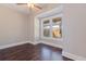 Bright bedroom with dark hardwood floors, a ceiling fan and a large window at 1225 22Nd S Ave, St Petersburg, FL 33705