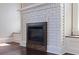 Close-up of the modern fireplace featuring a brick surround and a wooden frame for rustic charm at 1225 22Nd S Ave, St Petersburg, FL 33705