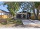 Charming home exterior featuring a pergola-covered patio, lush lawn, and paved driveway. Enjoy outdoor living at its finest at 1225 22Nd S Ave, St Petersburg, FL 33705