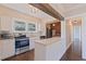 Well-lit kitchen boasts stainless steel appliances, granite countertops, and modern white cabinetry at 1225 22Nd S Ave, St Petersburg, FL 33705