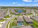Aerial view showcases a community with central water feature and many homes with screened-in pools at 13301 Waterleaf Garden Cir, Riverview, FL 33579