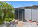 Backyard shed surrounded by white gravel, pavers, and a privacy fence with tropical foliage at 13301 Waterleaf Garden Cir, Riverview, FL 33579