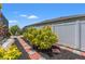 Landscaped backyard features stepping stones through black mulch, tropical plants, and a white privacy fence at 13301 Waterleaf Garden Cir, Riverview, FL 33579
