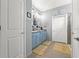 Bright bathroom featuring double vanity with powder blue cabinets and walk-in shower at 13301 Waterleaf Garden Cir, Riverview, FL 33579