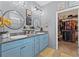 Bright bathroom featuring double vanity with powder blue cabinets and walk-in closet at 13301 Waterleaf Garden Cir, Riverview, FL 33579