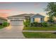 Charming single-Gathering home with a manicured lawn, two-car garage, and inviting curb appeal at 13301 Waterleaf Garden Cir, Riverview, FL 33579