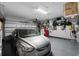 Attached garage featuring epoxy floor, overhead storage, and a vehicle at 13301 Waterleaf Garden Cir, Riverview, FL 33579