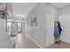 Inviting hallway with tiled floors, decorative mirror, and coat closet offers a warm welcome at 13301 Waterleaf Garden Cir, Riverview, FL 33579