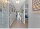 Hallway featuring tile flooring, neutral paint, and decorative wall hangings at 13301 Waterleaf Garden Cir, Riverview, FL 33579