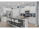 Spacious kitchen with island, granite counters, stainless appliances, and white cabinetry at 13301 Waterleaf Garden Cir, Riverview, FL 33579