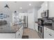 Bright kitchen with stainless appliances, granite countertops, and white cabinets at 13301 Waterleaf Garden Cir, Riverview, FL 33579
