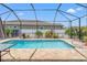 Screened-in pool with brick patio, manicured landscaping, and a backyard view at 13301 Waterleaf Garden Cir, Riverview, FL 33579