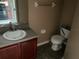 Modest bathroom featuring a single sink vanity and standard toilet at 15733 Stable Run Dr, Spring Hill, FL 34610