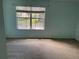 Bright bedroom with cozy carpeting, a large window overlooking the outdoors, and freshly painted walls at 15733 Stable Run Dr, Spring Hill, FL 34610