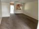 Open-concept living area with plush carpeting, neutral walls, and seamless flow into the kitchen area at 15733 Stable Run Dr, Spring Hill, FL 34610