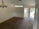 Spacious living room featuring neutral-colored walls, plush carpeting, and an abundance of natural light at 15733 Stable Run Dr, Spring Hill, FL 34610