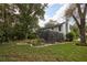 Expansive backyard featuring a screened enclosure and lush, mature landscaping creating a private oasis at 15917 Dover Cliffe Dr, Lutz, FL 33548