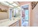 Well-lit bathroom with marble countertops, mirrored wall, and updated fixtures at 15917 Dover Cliffe Dr, Lutz, FL 33548