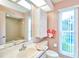 Bright bathroom with marble sink, cabinet, and natural light at 15917 Dover Cliffe Dr, Lutz, FL 33548