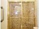 Bathroom featuring a shower stall enclosed with sliding glass doors and tiled walls at 15917 Dover Cliffe Dr, Lutz, FL 33548