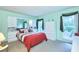 This bedroom features neutral carpeting, two windows, and a mirrored dresser with decorative accents at 15917 Dover Cliffe Dr, Lutz, FL 33548