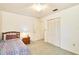 Well-lit bedroom with closet, bed, and wooden dresser at 15917 Dover Cliffe Dr, Lutz, FL 33548