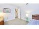 This bedroom includes neutral carpeting, a window, and a doorway leading to other areas of the home at 15917 Dover Cliffe Dr, Lutz, FL 33548