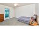 Bright bedroom with window, dresser, and cozy bed at 15917 Dover Cliffe Dr, Lutz, FL 33548
