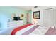 Inviting bedroom with comfortable queen size bed, closet, and a bright color scheme at 15917 Dover Cliffe Dr, Lutz, FL 33548