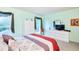 Comfortable bedroom with large bed, dresser, and natural light from the windows at 15917 Dover Cliffe Dr, Lutz, FL 33548