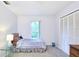 This bedroom features neutral carpeting, a window for natural light, and a spacious closet with bi-fold doors at 15917 Dover Cliffe Dr, Lutz, FL 33548