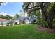 Charming home surrounded by mature trees and lush landscaping, providing a peaceful and private setting at 15917 Dover Cliffe Dr, Lutz, FL 33548