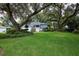 Beautiful home with mature trees and lush green lawn offering great curb appeal at 15917 Dover Cliffe Dr, Lutz, FL 33548