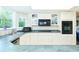 Functional kitchen with white cabinetry, black appliances, and plenty of counter space at 15917 Dover Cliffe Dr, Lutz, FL 33548