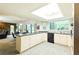 Bright kitchen with white cabinets, gray countertops, and modern appliances at 15917 Dover Cliffe Dr, Lutz, FL 33548