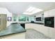 Well-lit kitchen featuring white cabinets, modern appliances, and a skylight at 15917 Dover Cliffe Dr, Lutz, FL 33548