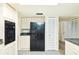 Efficient kitchen with white cabinets, black appliances, and ample storage space at 15917 Dover Cliffe Dr, Lutz, FL 33548