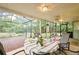 Cozy screened lanai featuring outdoor dining, ceiling fan, and views of the beautifully landscaped backyard at 15917 Dover Cliffe Dr, Lutz, FL 33548