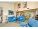 Bright living room featuring vaulted ceilings, large windows, and comfortable blue sofas at 15917 Dover Cliffe Dr, Lutz, FL 33548