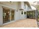 Paver patio provides a smooth transition to the home's sliding glass doors and an airy screened in porch at 15917 Dover Cliffe Dr, Lutz, FL 33548