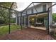 A screened-in patio with views of a lush backyard, connected to an outdoor patio with dining table at 15917 Dover Cliffe Dr, Lutz, FL 33548