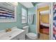 Charming bathroom with a pristine white sink and toilet, complemented by light blue walls and nautical themed decor at 15925 Marshfield Dr, Tampa, FL 33624